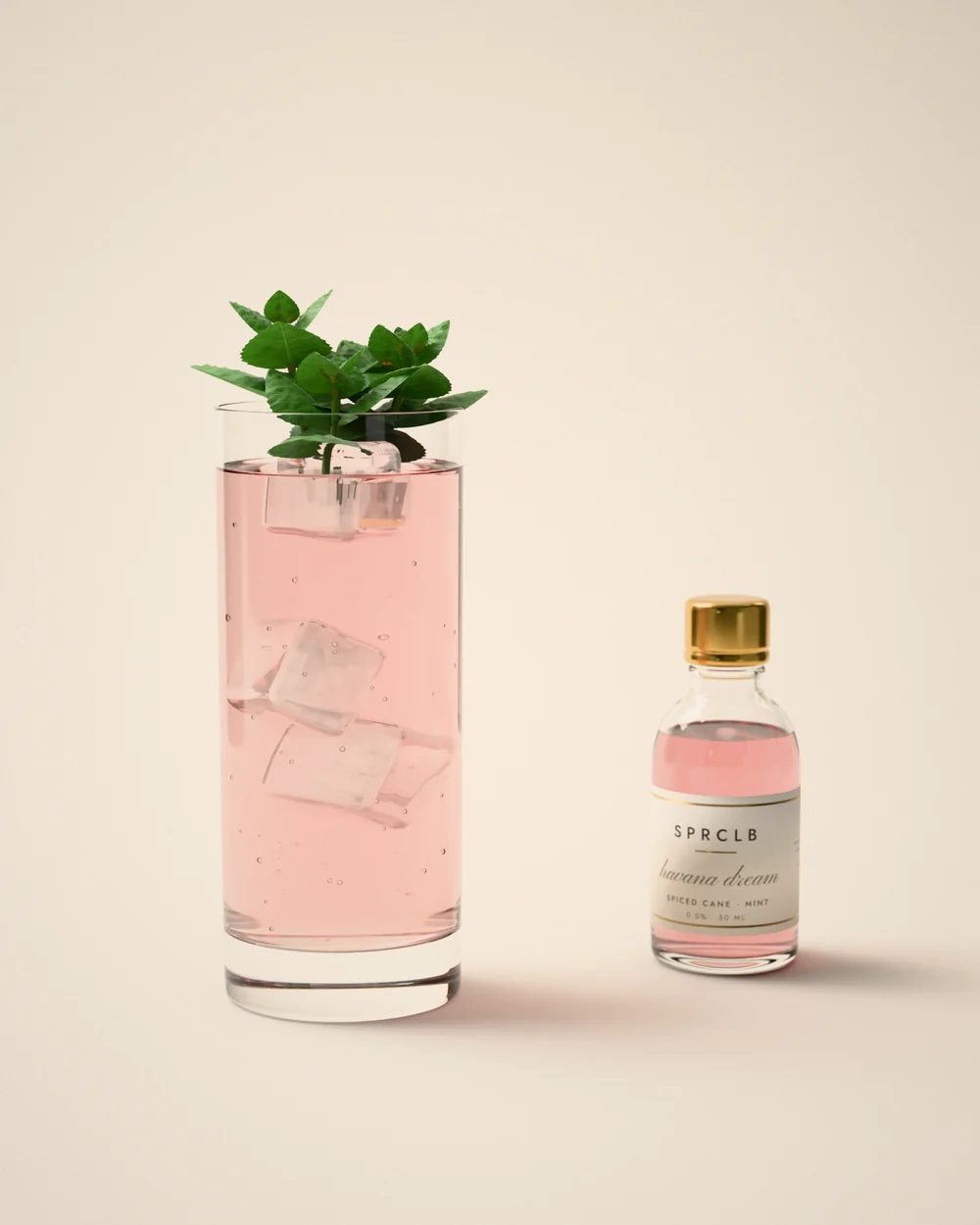 Havana Dream: a long blush-rose cooler over ice in a highball with a sprig of mint, beside a small clear SPRCLB syrup bottle